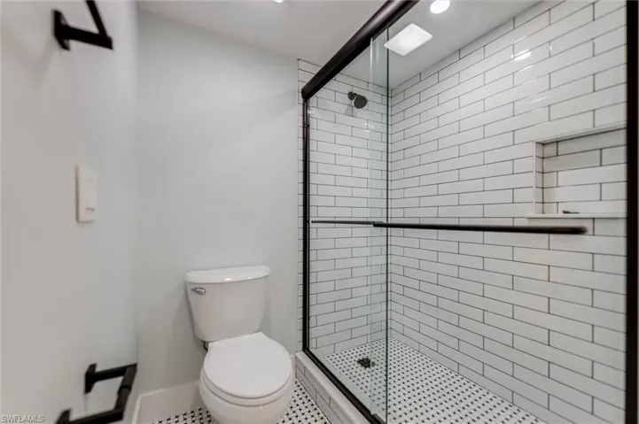 Full bathroom with a shower stall