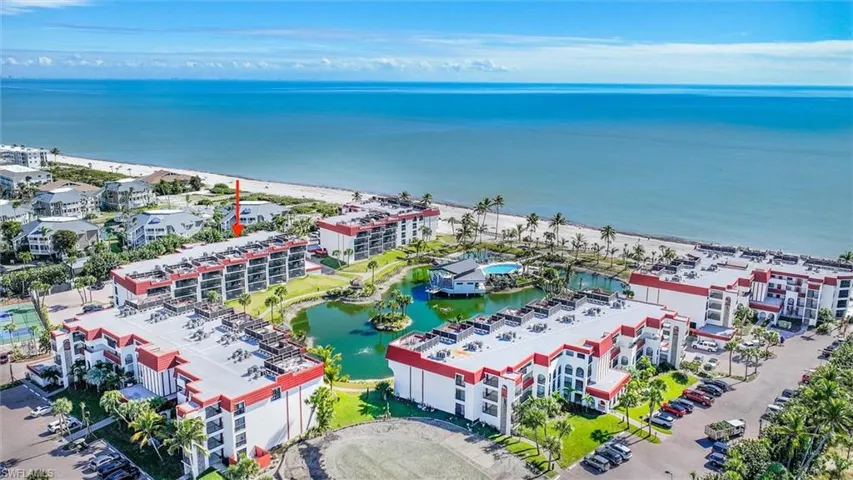 Drone / aerial view of apartment complex / building and a large body of water