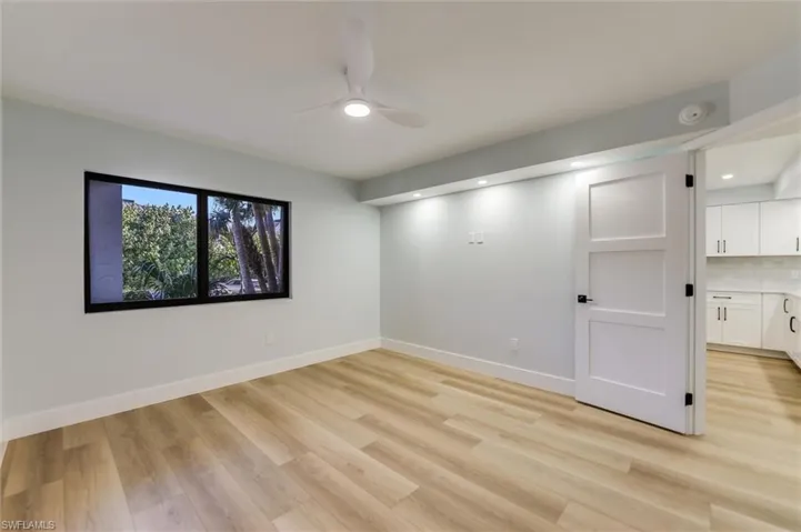 Spare room with a ceiling fan and light wood-style floors