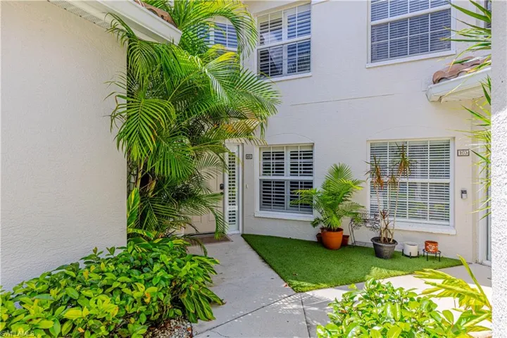 Doorway to property with stucco siding