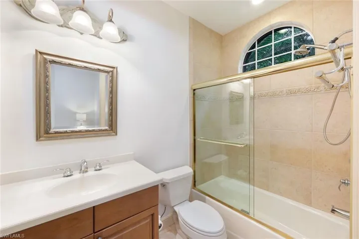 Ensuite bathroom for third bedroom with tub and shower.