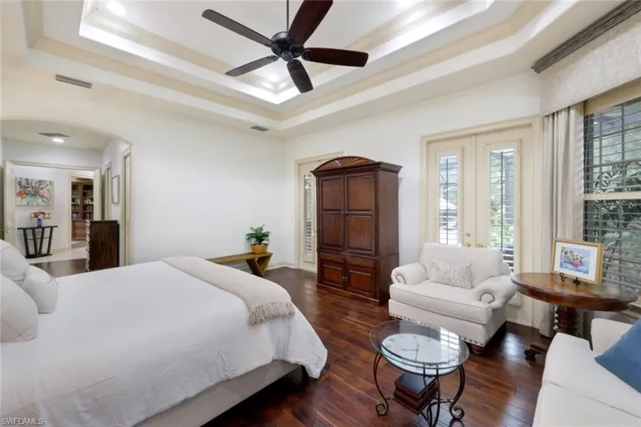 The blissful and expansive primary suite has private access to the lanai, a bay window, two walk in closets, and a large ensuite bathroom with private garden area.