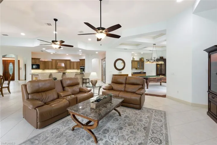 The family room opens up to the lanai for a wonderful indoor/outdoor living experience. The open floor plan allows this space to flow seamlessly to the game room, kitchen, and dining area.