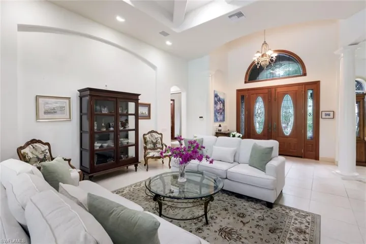 Entryway opens up to the great room with soaring ceilings and views onto the lanai.