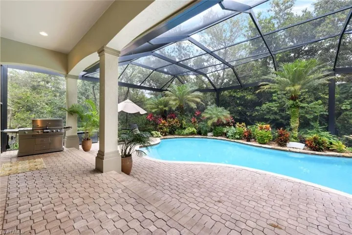 The lanai is impressive and inviting with plenty of space to grill, dine, or relax by the pool, or soak in the hot tub.
