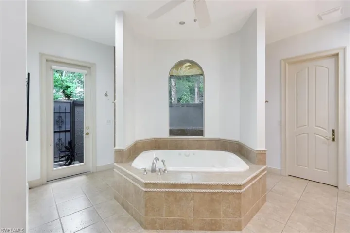 The primary ensuite bathroom includes a walk-in shower, soaking tub, and private outdoor garden area.