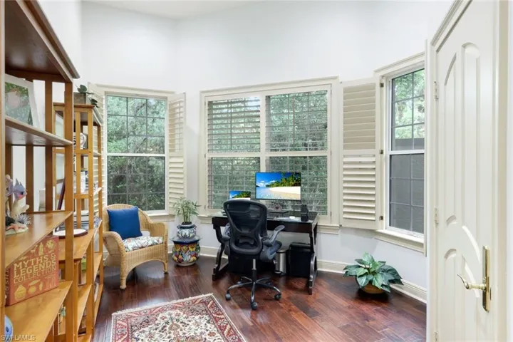 The office is located in the primary suite and features large windows letting in lots of lovely natural light!