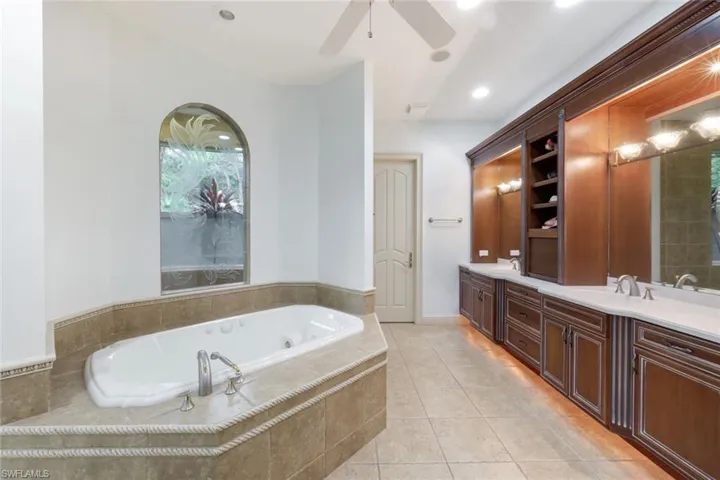 The primary ensuite bathroom includes a walk-in shower, soaking tub, and private outdoor garden area.