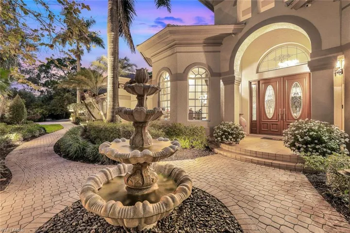 Inviting sounds of the tiered fountain welcome you as you enter the home.