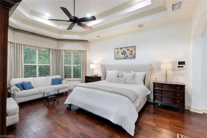 The blissful and expansive primary suite has private access to the lanai, a bay window, two walk in closets, and a large ensuite bathroom with private garden area.