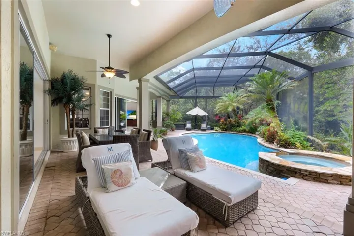The lanai is impressive and inviting with plenty of space to grill, dine, or relax by the pool, or soak in the hot tub.