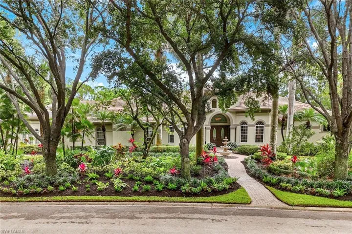 Beautiful view showing the front of the home, with large live oak trees that line the street.