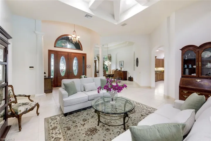 Entryway opens up to the great room with soaring ceilings and views onto the lanai.