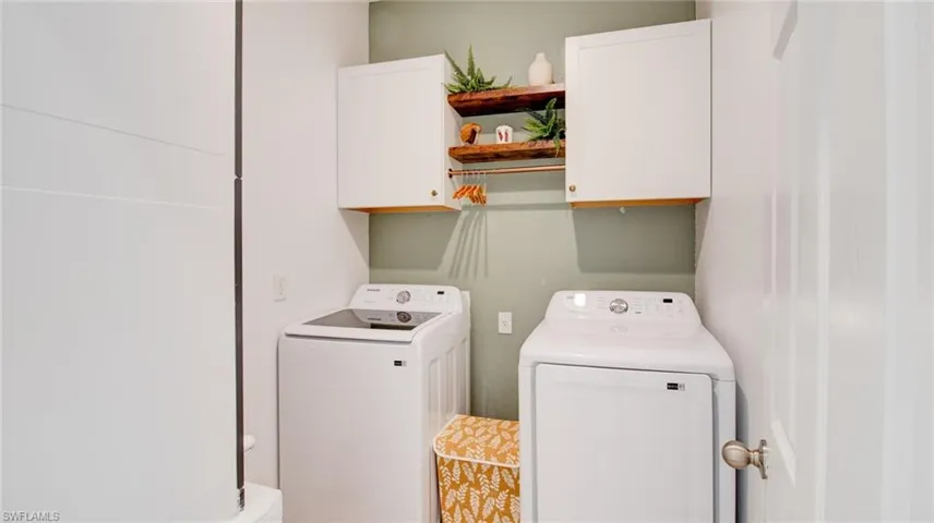 Laundry room featuring washer and dryer and cabinet space