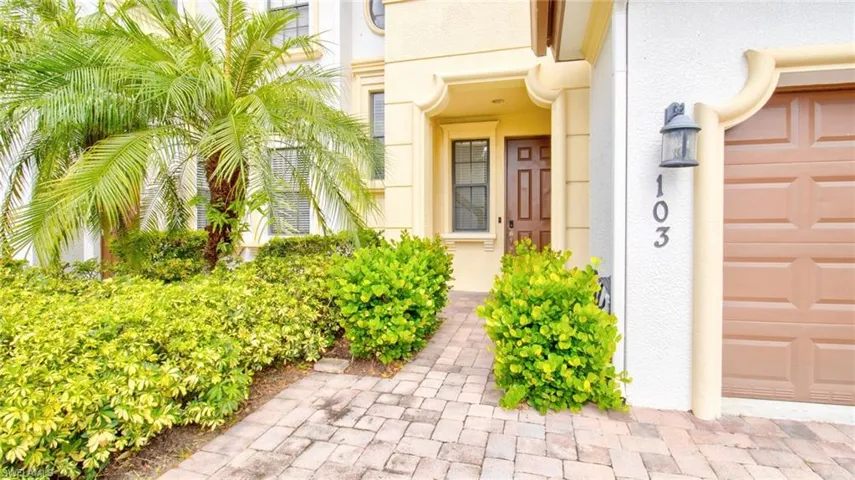 Property entrance with stucco siding and a garage