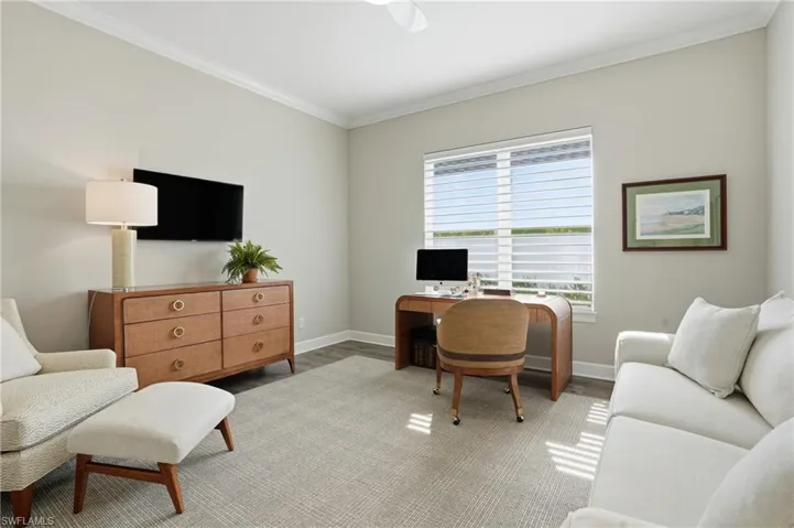 Home office with ornamental molding and wood finished floors