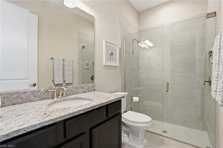 Full bathroom featuring vanity and a stall shower