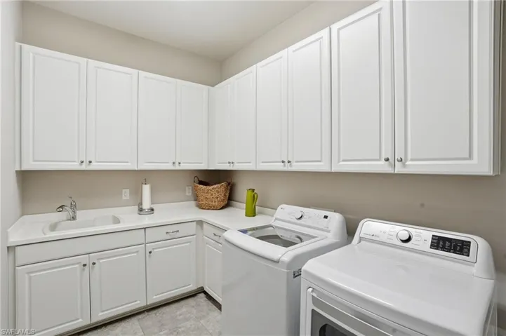 Washroom with washer and dryer and cabinet space