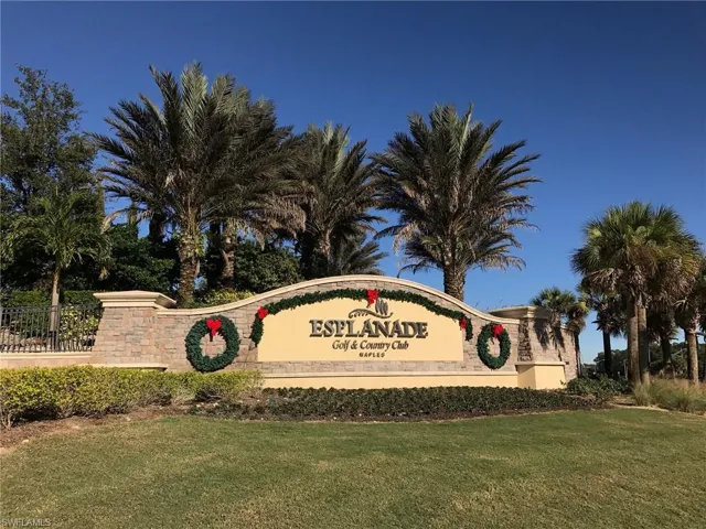 Community / neighborhood sign with a yard
