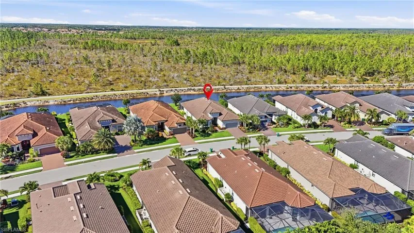 Aerial perspective of suburban area featuring a nearby body of water