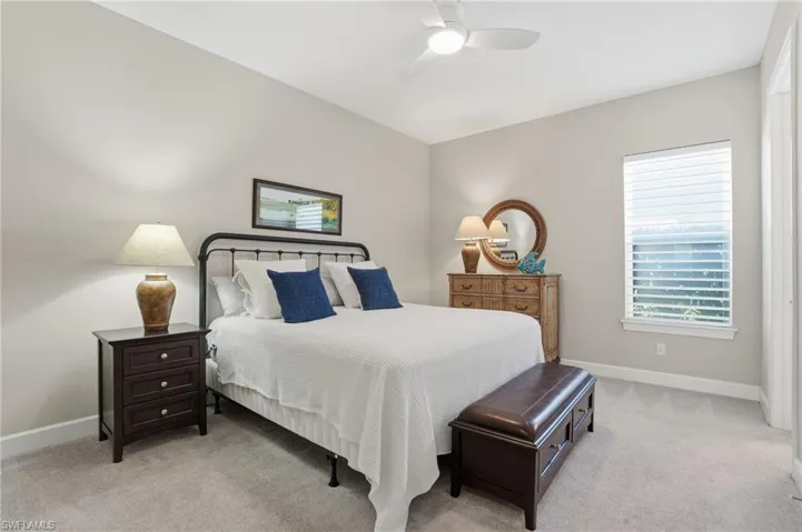 Bedroom with light colored carpet and ceiling fan