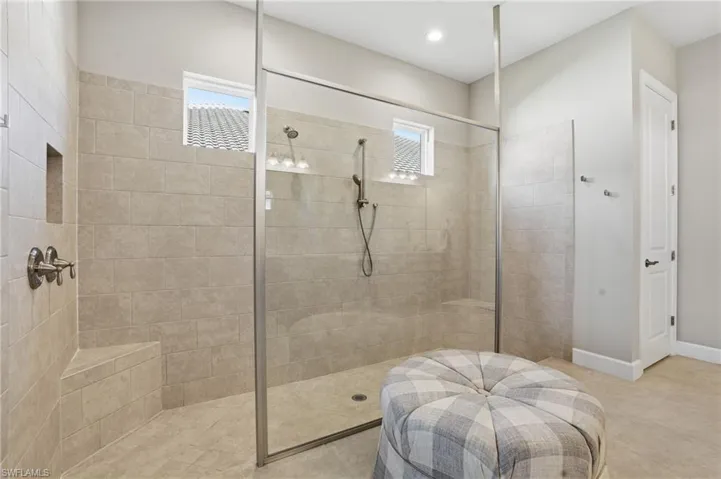 Bathroom with a walk in shower and recessed lighting