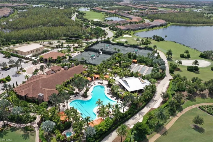 Aerial view of property and surrounding area featuring a large body of water and a golf club