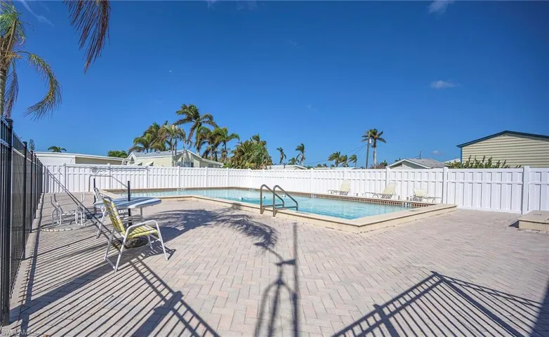 Pool featuring a patio area and fence