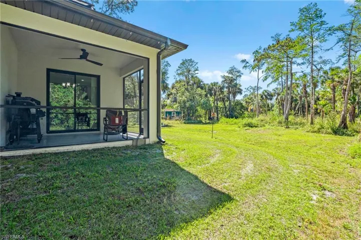 View of yard with a patio area and ceiling fan