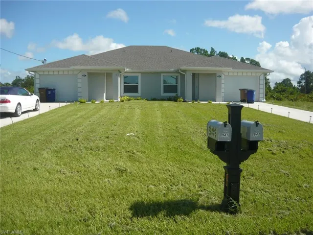 Ranch-style home with a garage and a front lawn