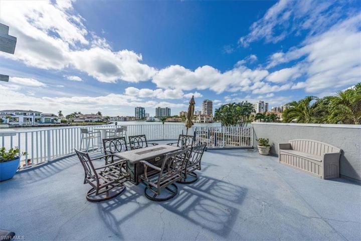 Above the pool is a terrace with another grill