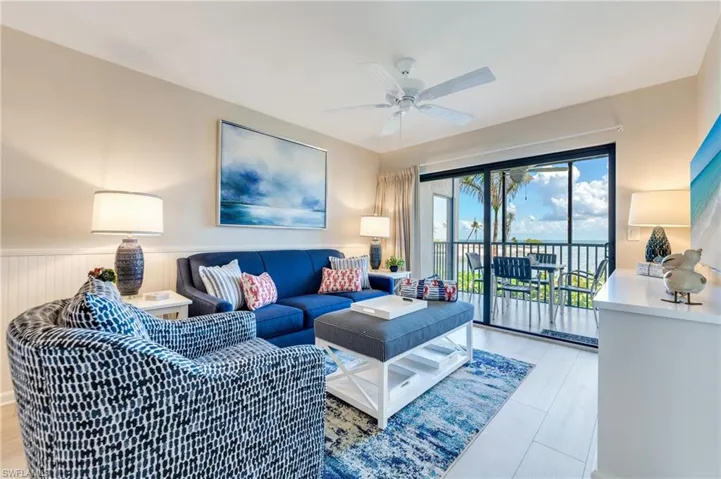 Living area featuring a spacious balcony with sliding glass doors, extending the interior space