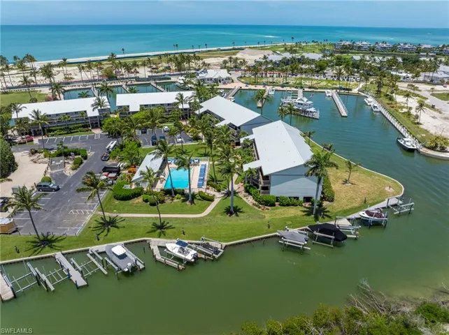 Waterfront property featuring multiple boat slips, a swimming pool, and direct access to open water