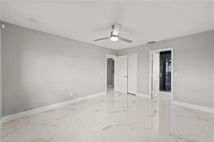 Unfurnished bedroom featuring ceiling fan and a closet
