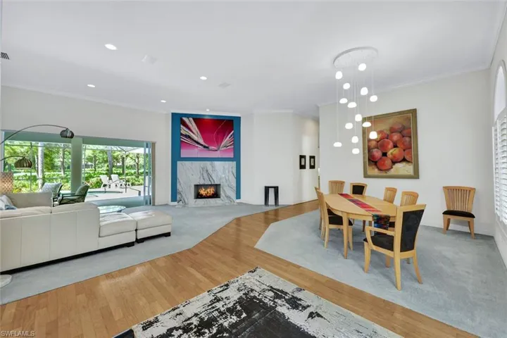 Foyer to Flowing Living-Dining Layout with Gas Fireplace in Marble Surround