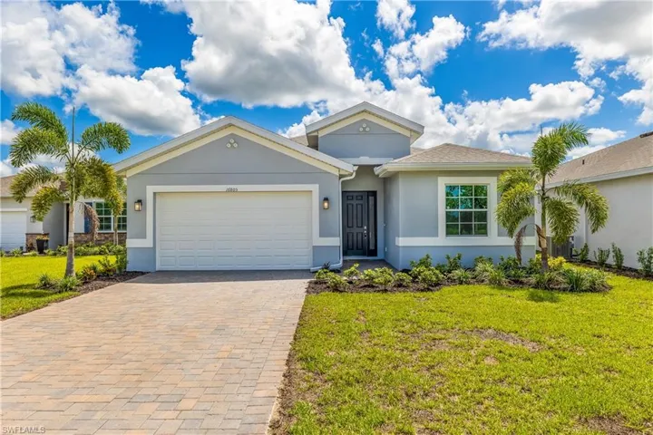 Ranch-style house featuring stucco siding, decorative driveway, an attached garage, and a front yard
