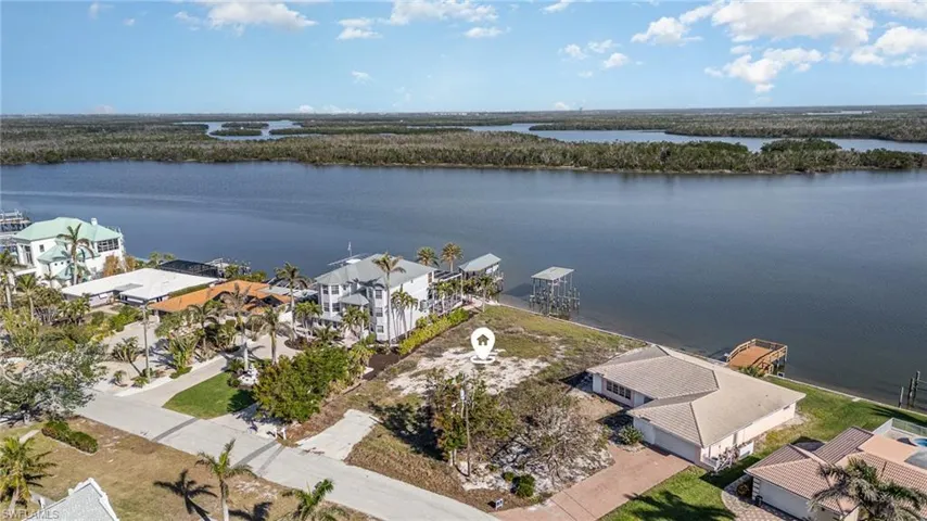 Aerial view of residential area featuring a nearby body of water