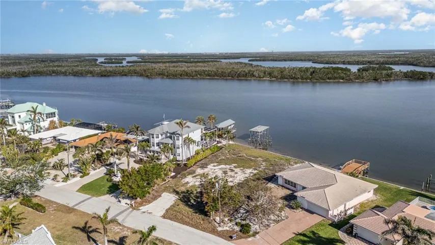 Aerial view of lot and surrounding properties
