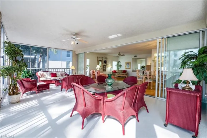 Dining space featuring ceiling fan, a textured ceiling, and a wall of windows