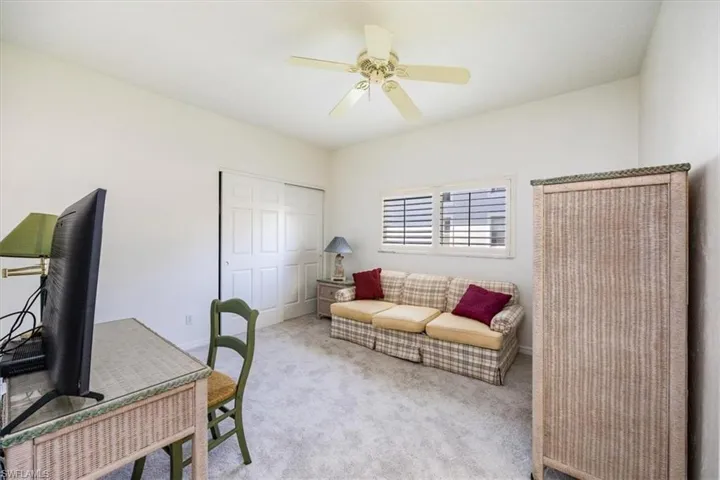 Office featuring ceiling fan and light carpet