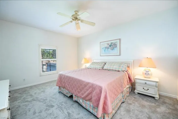 Carpeted bedroom with ceiling fan