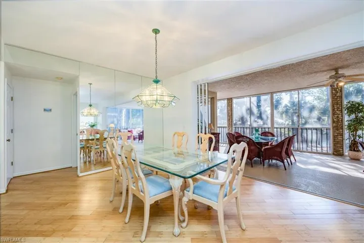 Dining room with ceiling fan, light wood-type flooring, and a wealth of natural light