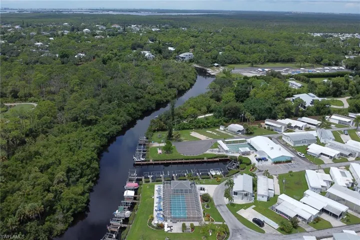 Bird's eye view of a nearby body of water and a heavily wooded area