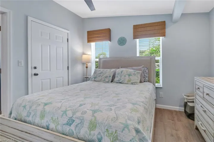 Bedroom featuring lofted ceiling, light wood-style flooring, and ceiling fan