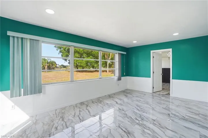Spare room with recessed lighting and light marble finish floors