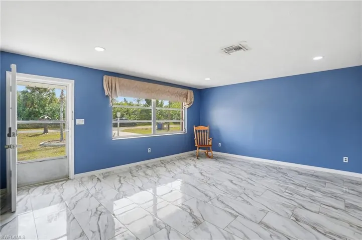Unfurnished room with light marble finish flooring and recessed lighting