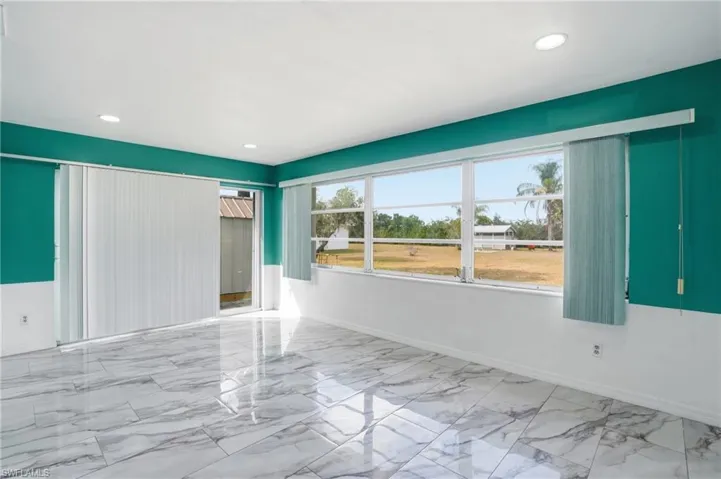 Unfurnished room featuring baseboards and recessed lighting