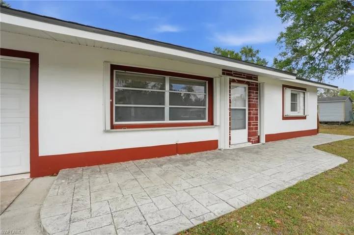 Property entrance featuring a patio area and stucco siding