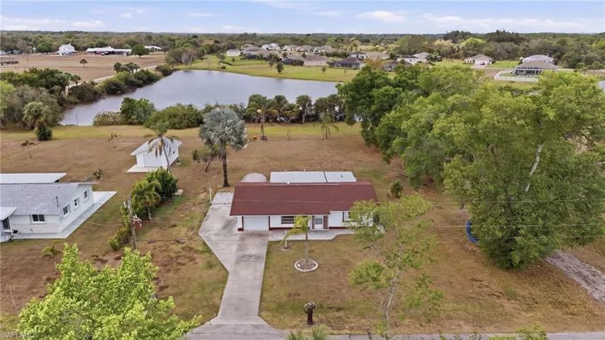 Bird's eye view of a nearby body of water and a tree filled landscape