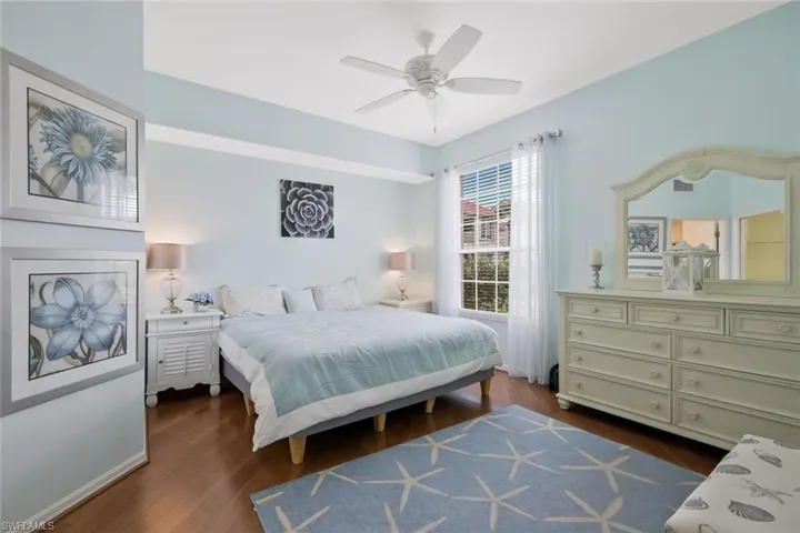 Bedroom with dark wood finished floors and ceiling fan